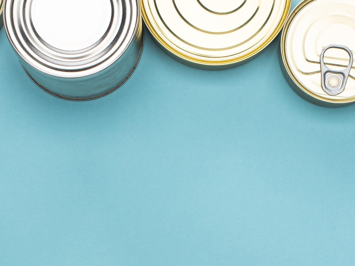 A row of sealed food cans against a blue background